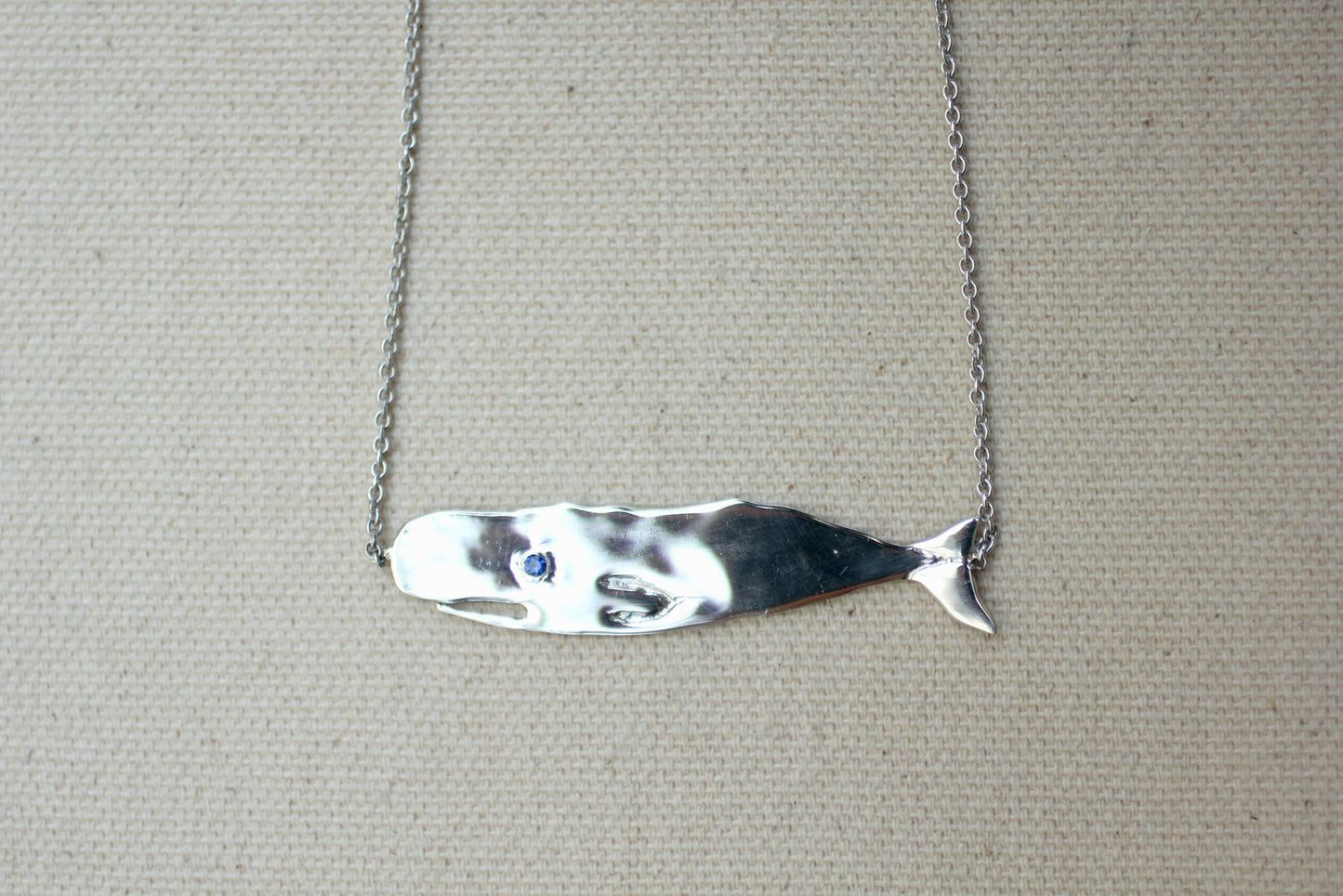Sapphire and Sterling Silver Hand-Carved Flat Whale Necklace handmade by Jewel in the Sea Nantucket