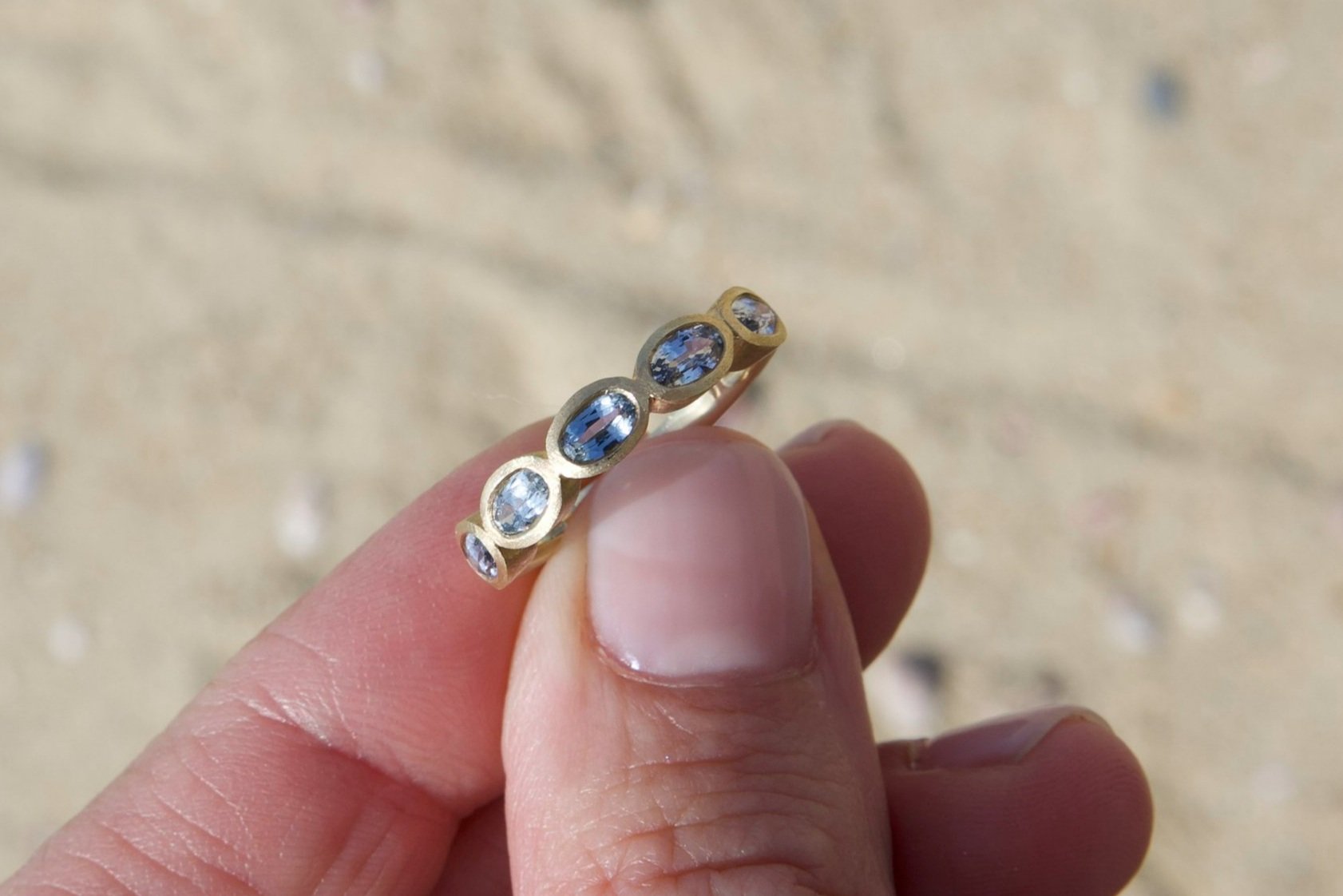 Light Sapphire 5-Stone Ring, bezel-set and featuring a 14K Yellow Gold satin finish handmade by Jewel in the Sea Nantucket